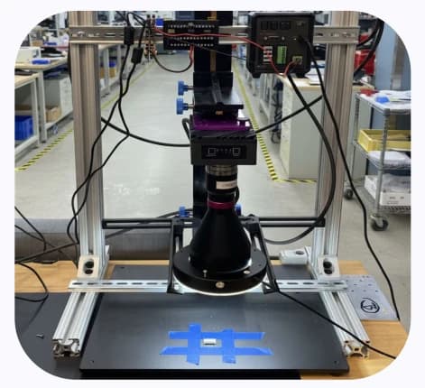 The OV80i mounted on an extrusion frame above the connector with the telecentric lens and ring light